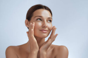 Peptides skincare. Woman touching healthy facial skin.
