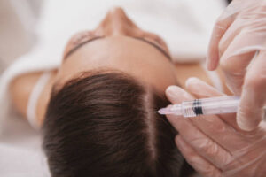 Woman gets a hair treatment with injection - peptides for hair growth